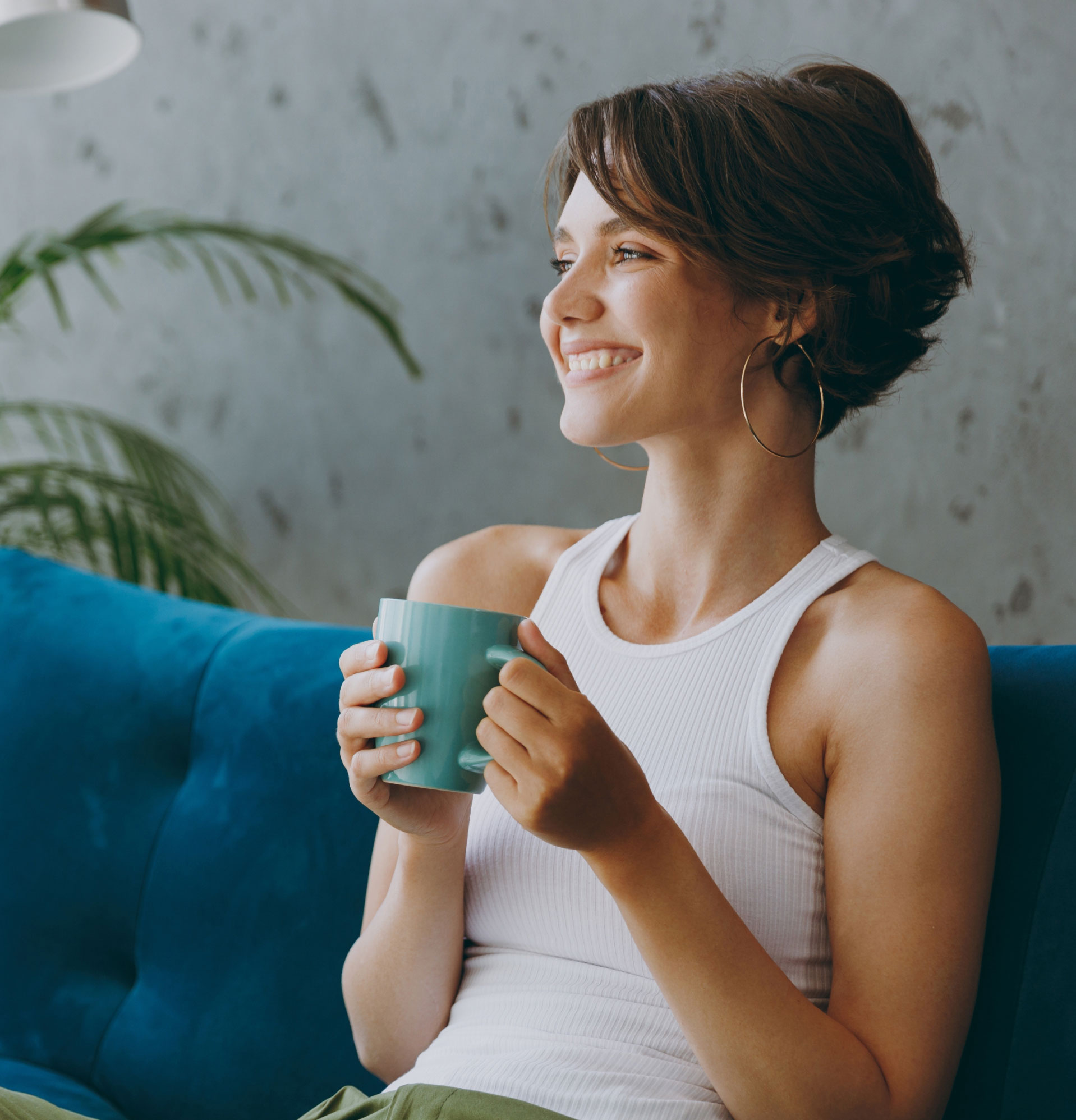 mishawaka woman enjoying coffee on a couch