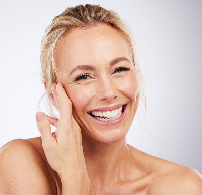 woman smiling feeling her soft skin after chemical peel
